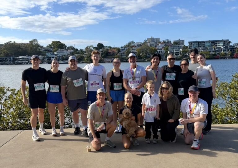 The Brokerage and Friends team gathered beside the Brisbane River after Run2Cure Neuroblastoma 2026