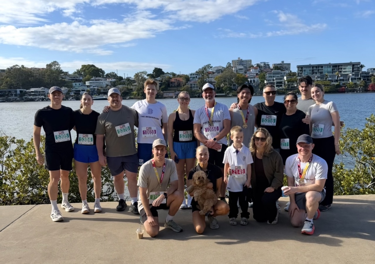 The Brokerage and Friends team gathered beside the Brisbane River after Run2Cure Neuroblastoma 2026