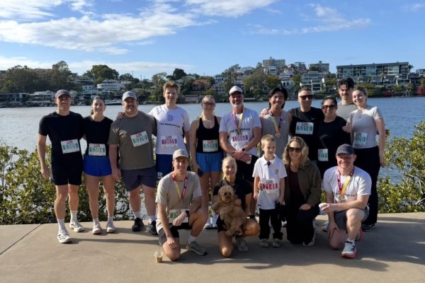 The Brokerage and Friends team gathered beside the Brisbane River after Run2Cure Neuroblastoma 2026